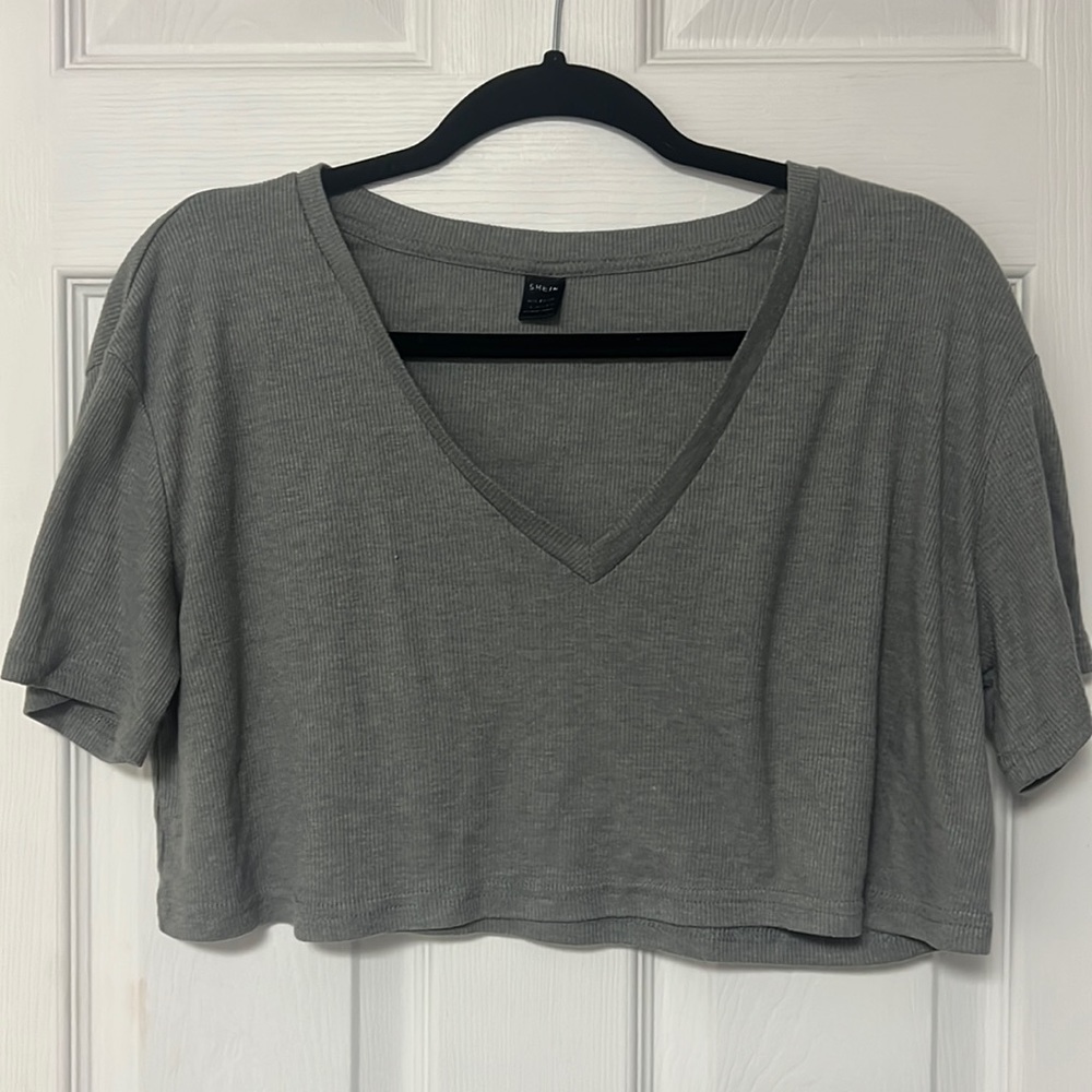 Gray cropped shirt . So cute. It’s very short on.
